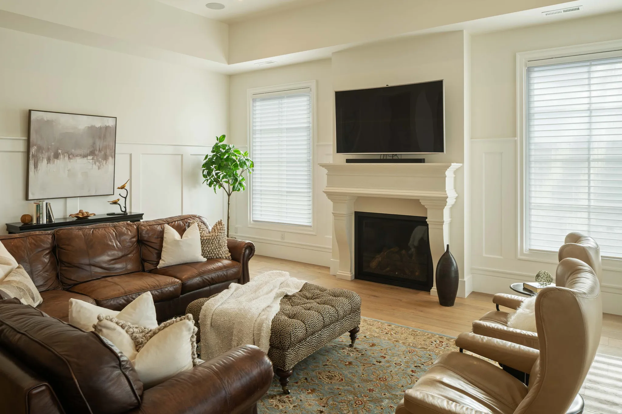 Living area featuring a classic fireplace with ornate mantel, flanked by two large windows