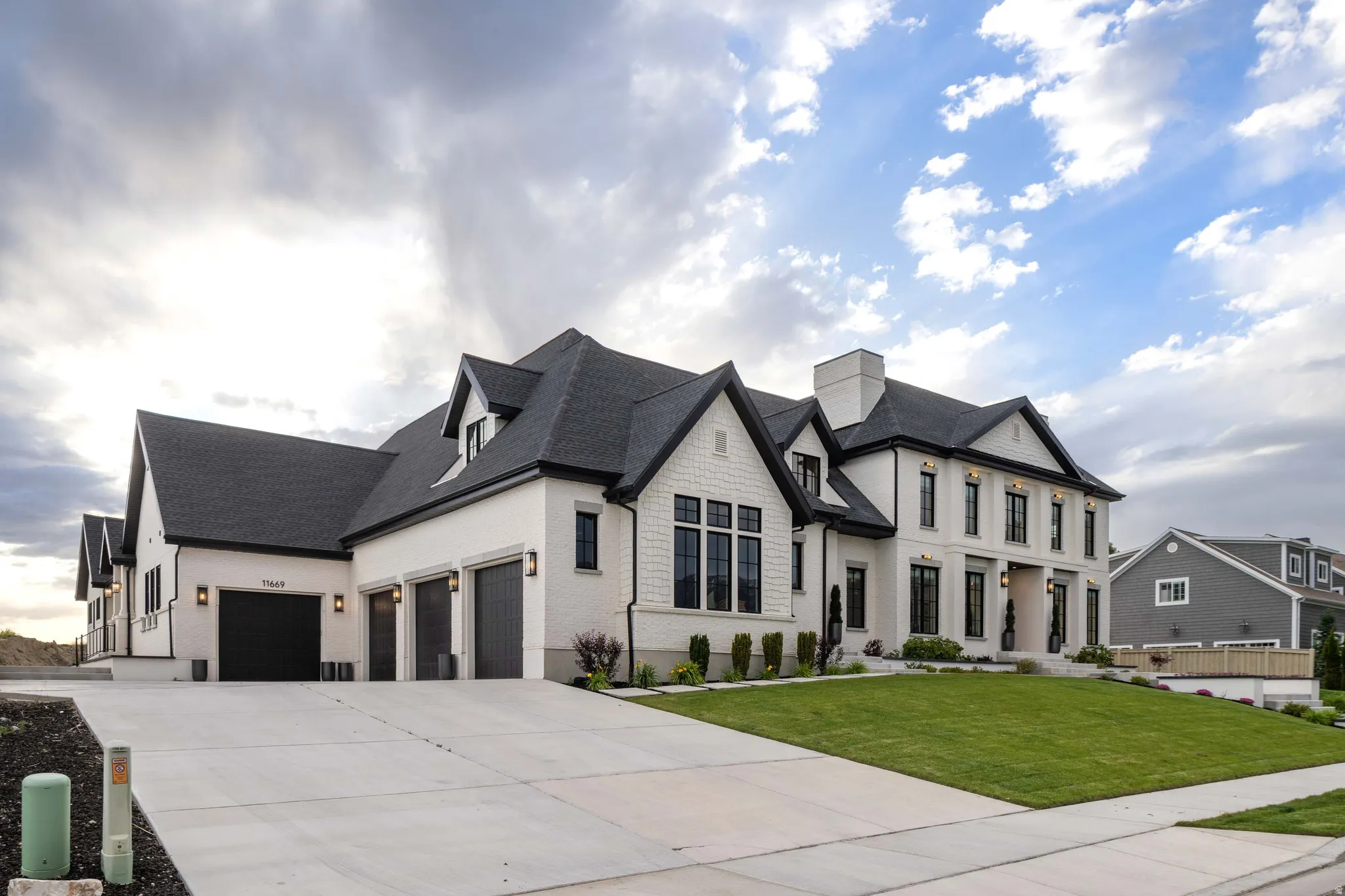 Modern farmhouse exterior featuring white brick and dark trim