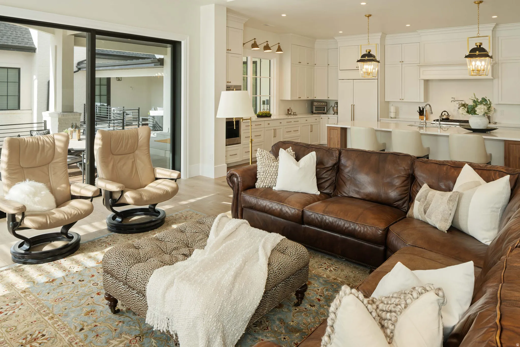 Open-concept living area featuring light wood-finish flooring and a large area rug