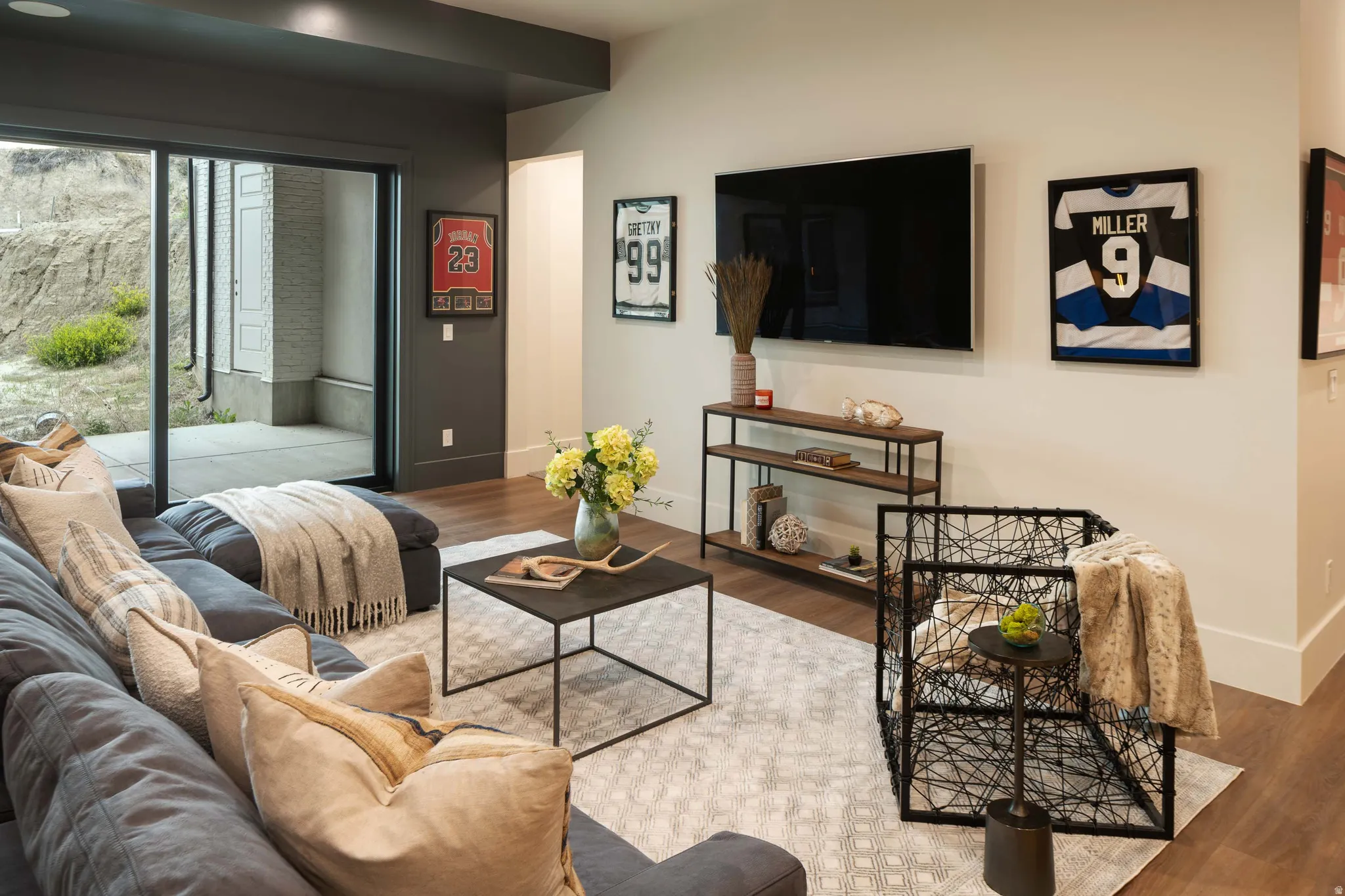 Spacious living area featuring expansive glass sliding doors providing direct outdoor access