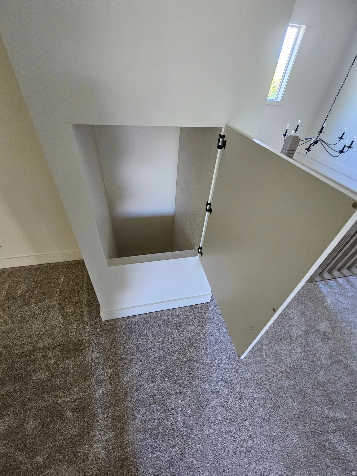 Built-in under-stair storage with an open door, showcasing the interior space