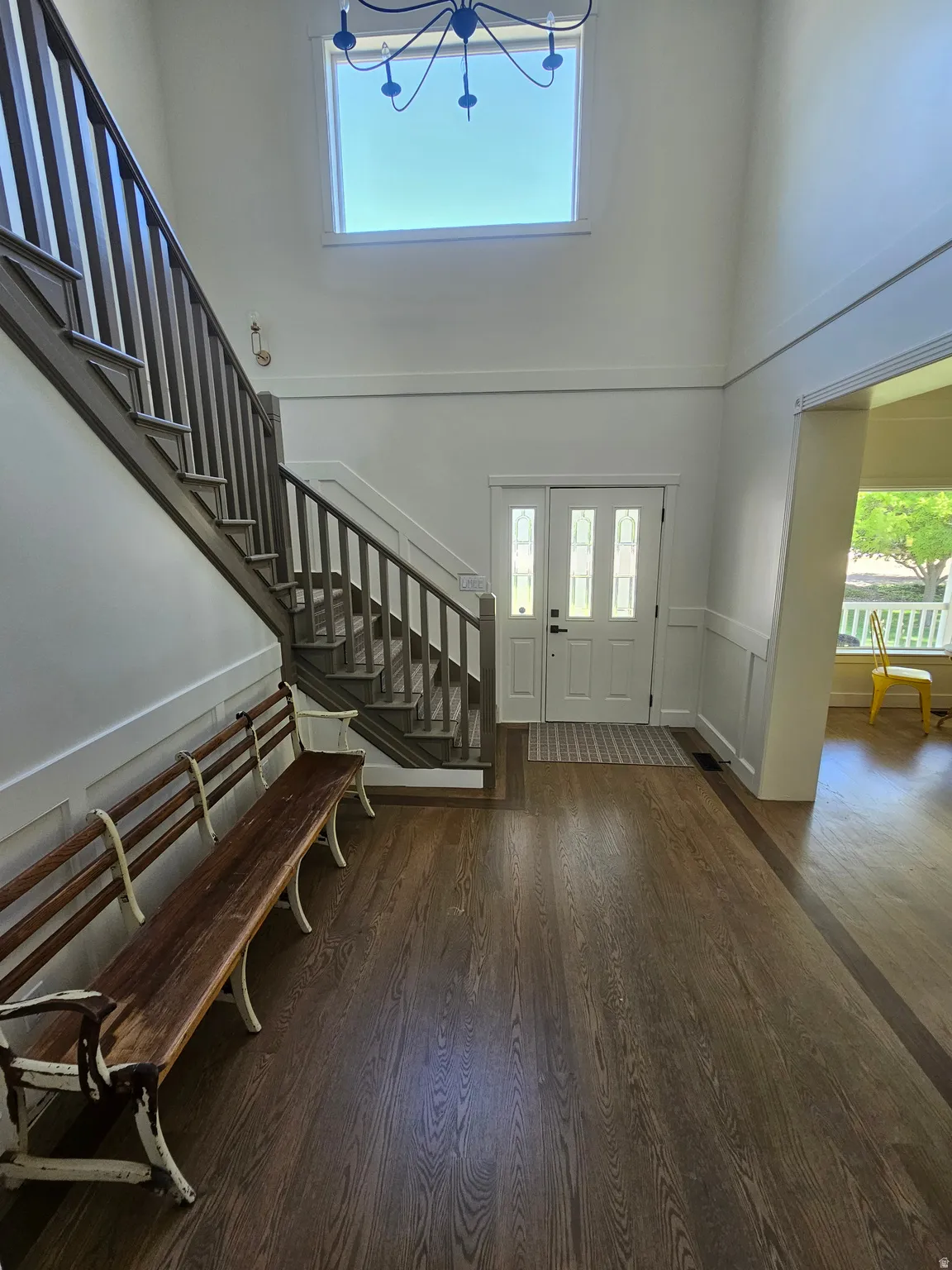 Grand entry foyer featuring high ceilings and wood-finish flooring