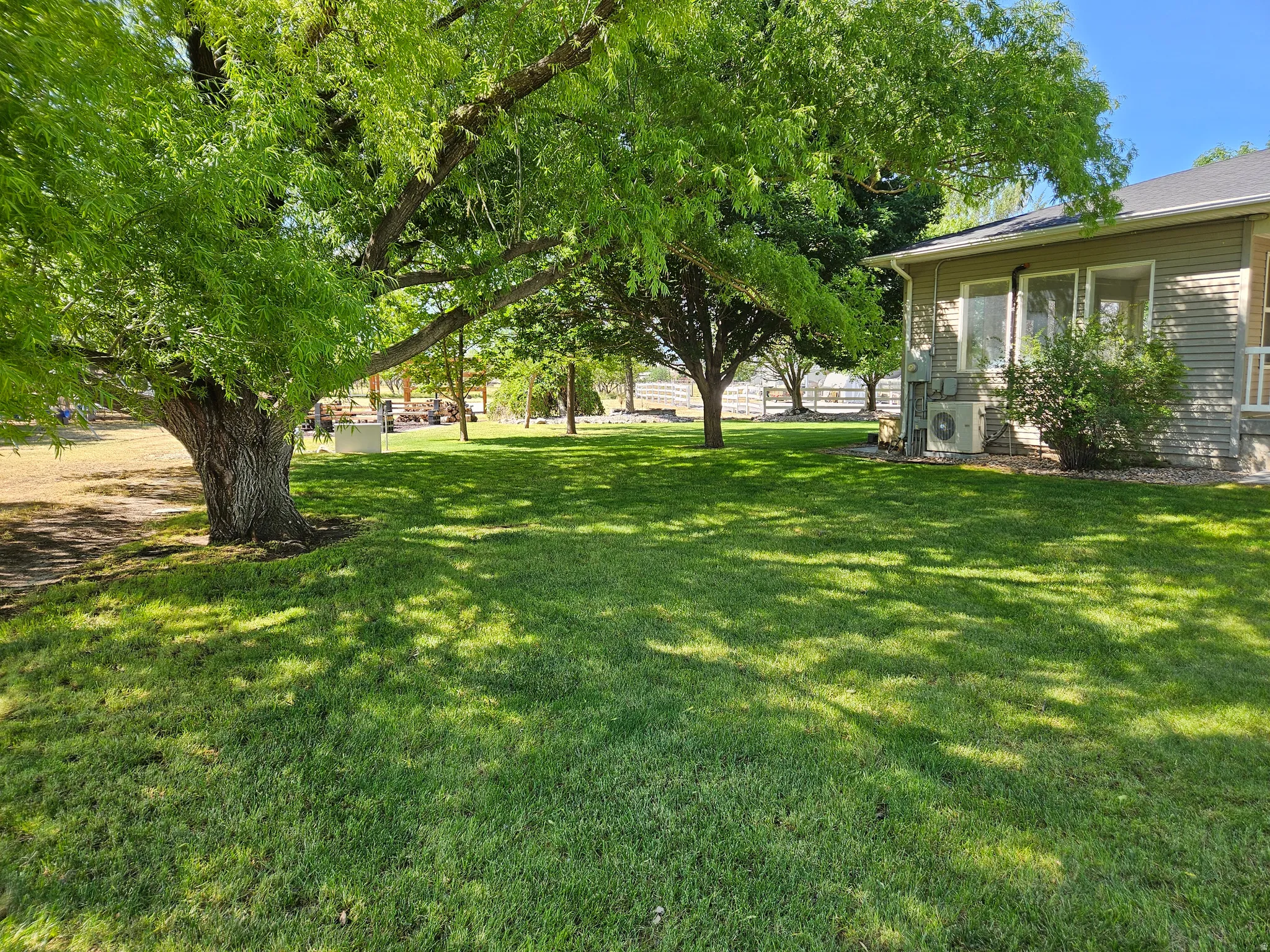 Expansive green lawn with mature shade trees