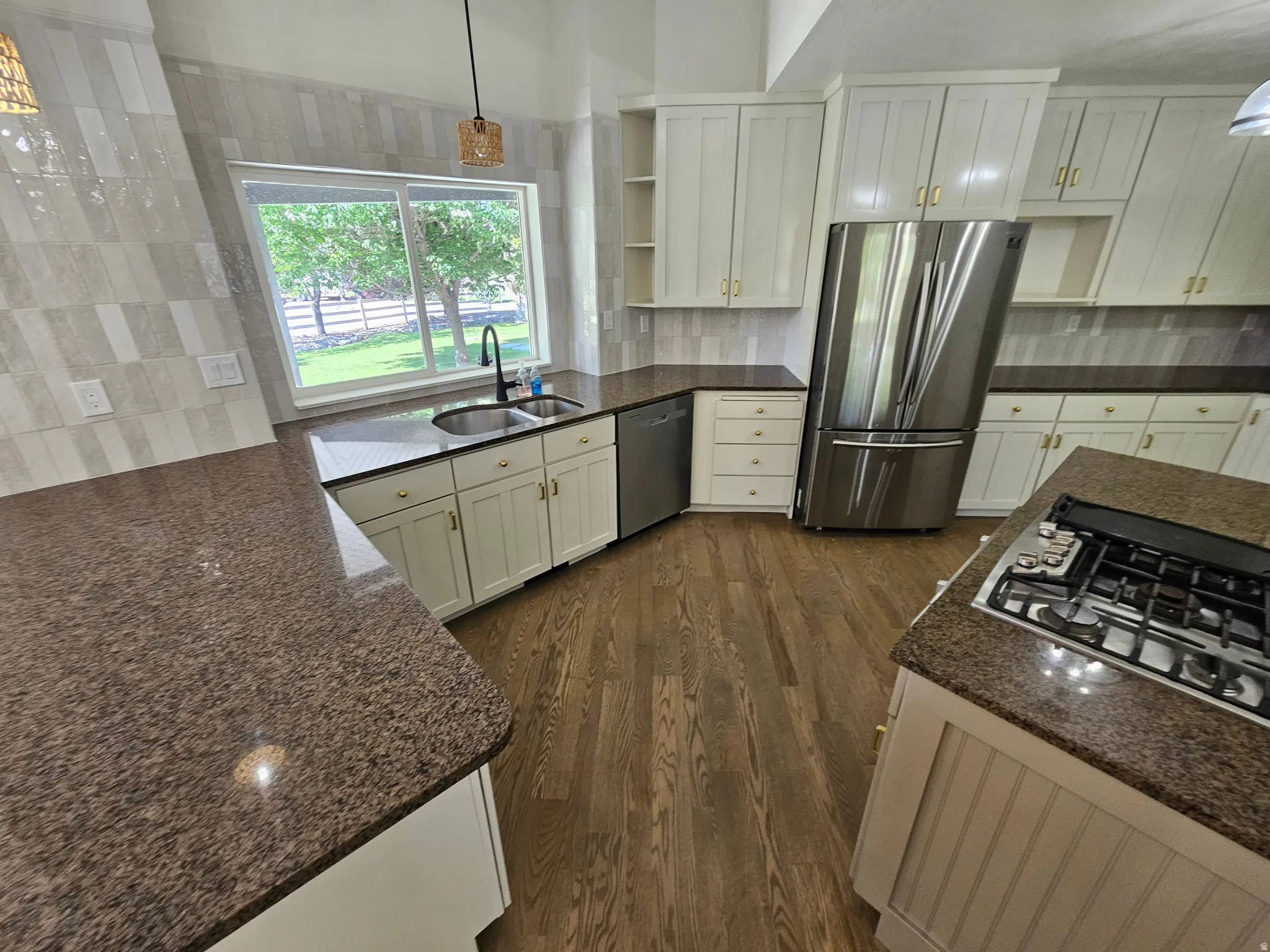 Kitchen featuring wood-finish flooring and light-toned cabinetry