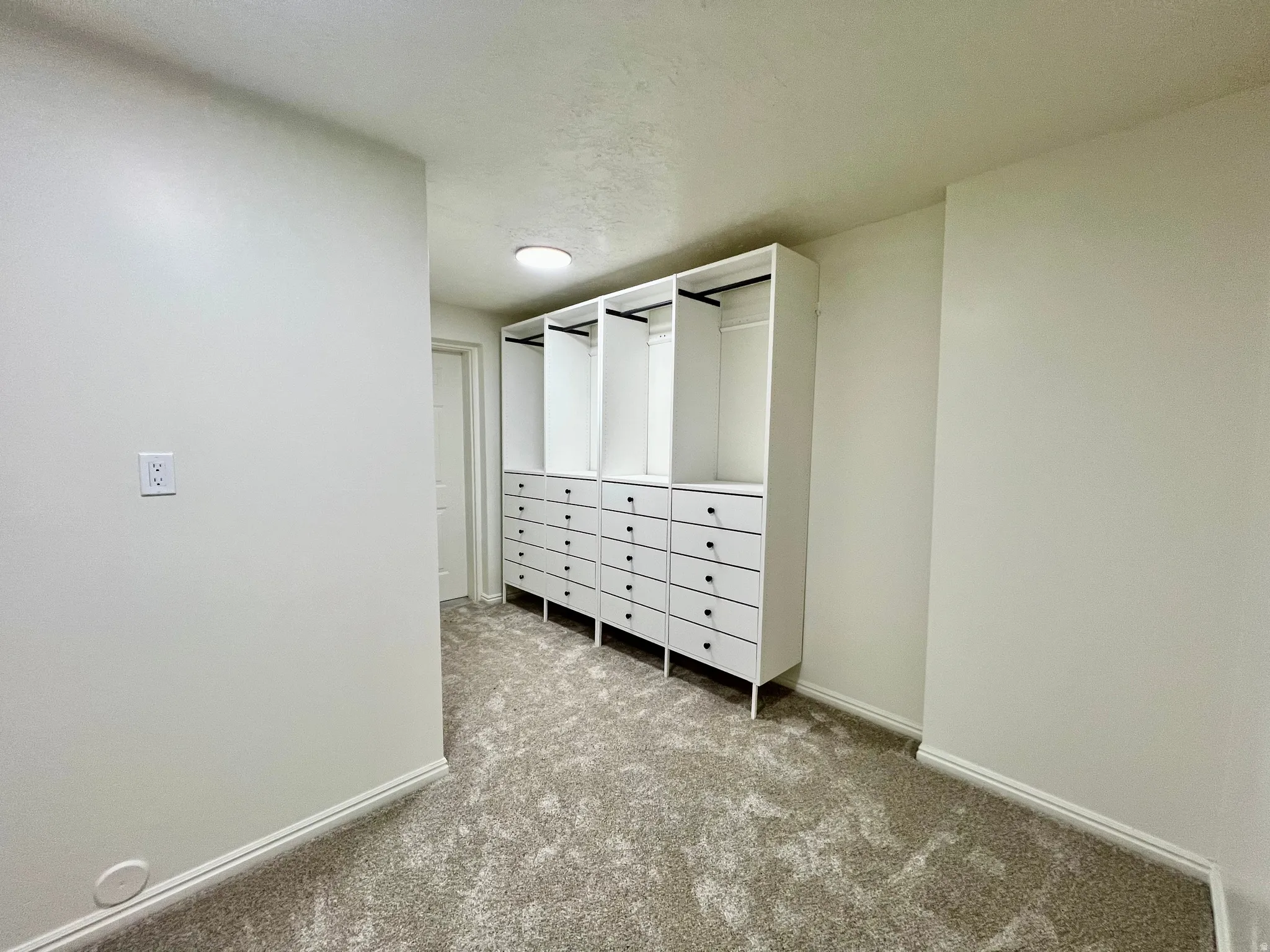 Built-in closet system featuring multiple drawers and hanging rods