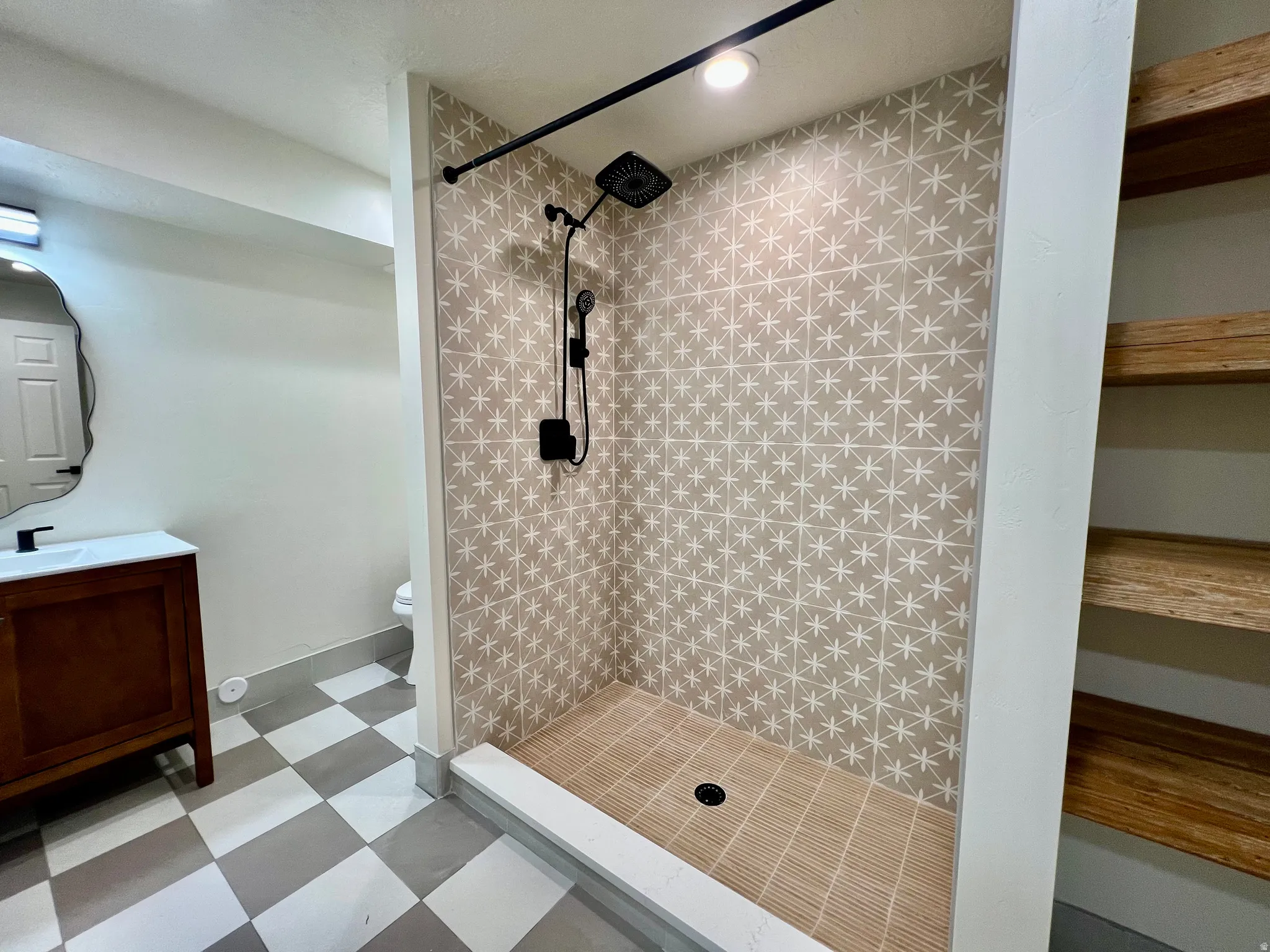 Contemporary walk-in shower featuring patterned wall tile and a slatted floor