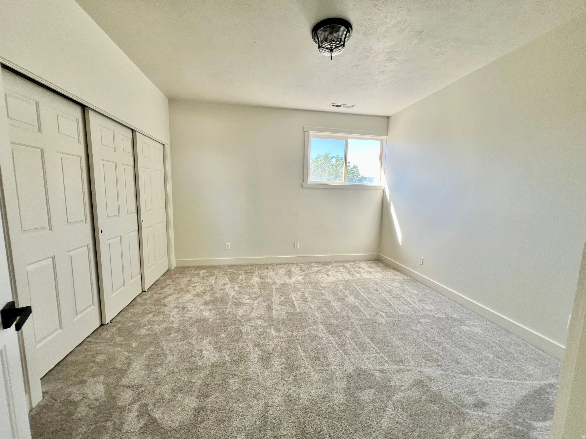 Neutral-toned carpeting paired with light walls and trim