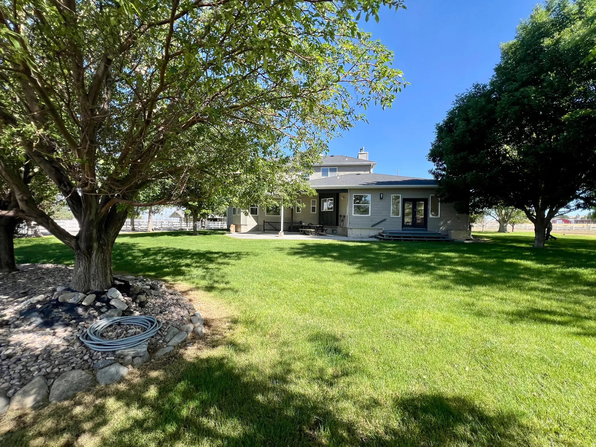 Expansive green lawn with mature shade trees