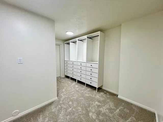 Built-in closet system featuring multiple drawers and hanging rods