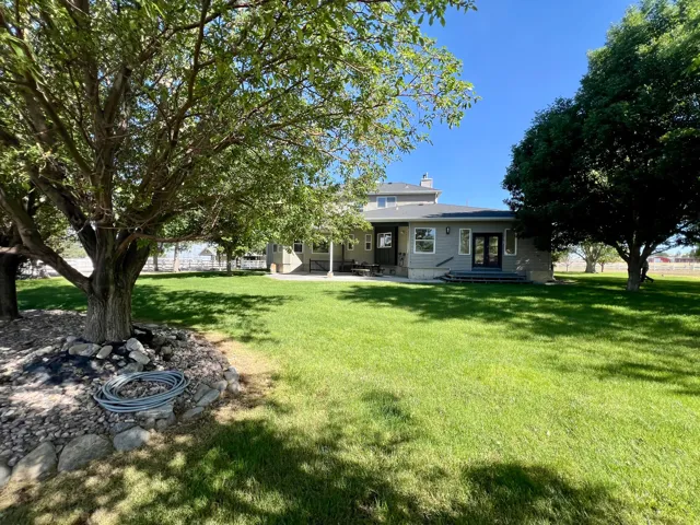 Expansive green lawn with mature shade trees