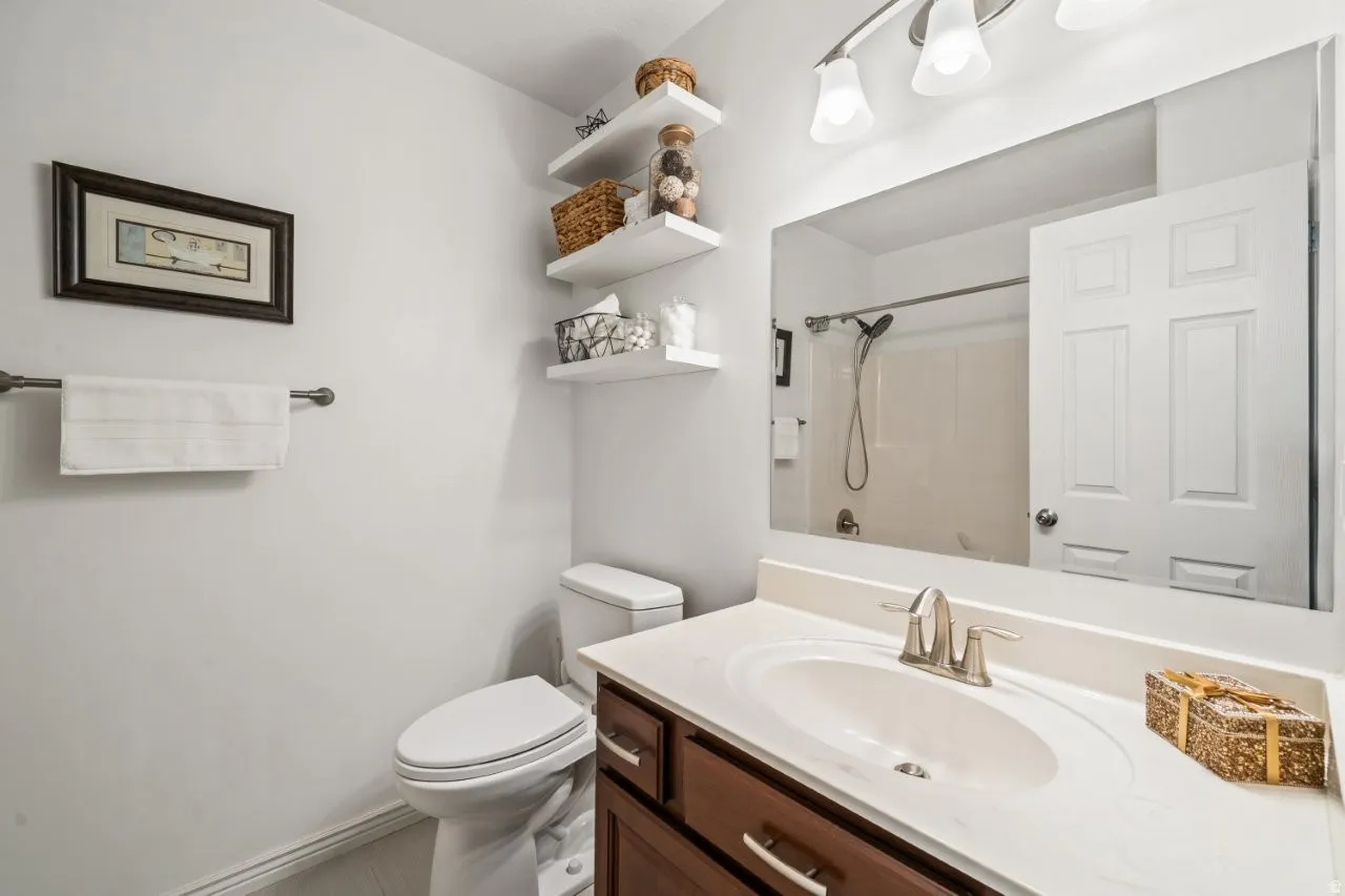 Full bath with vanity and a shower