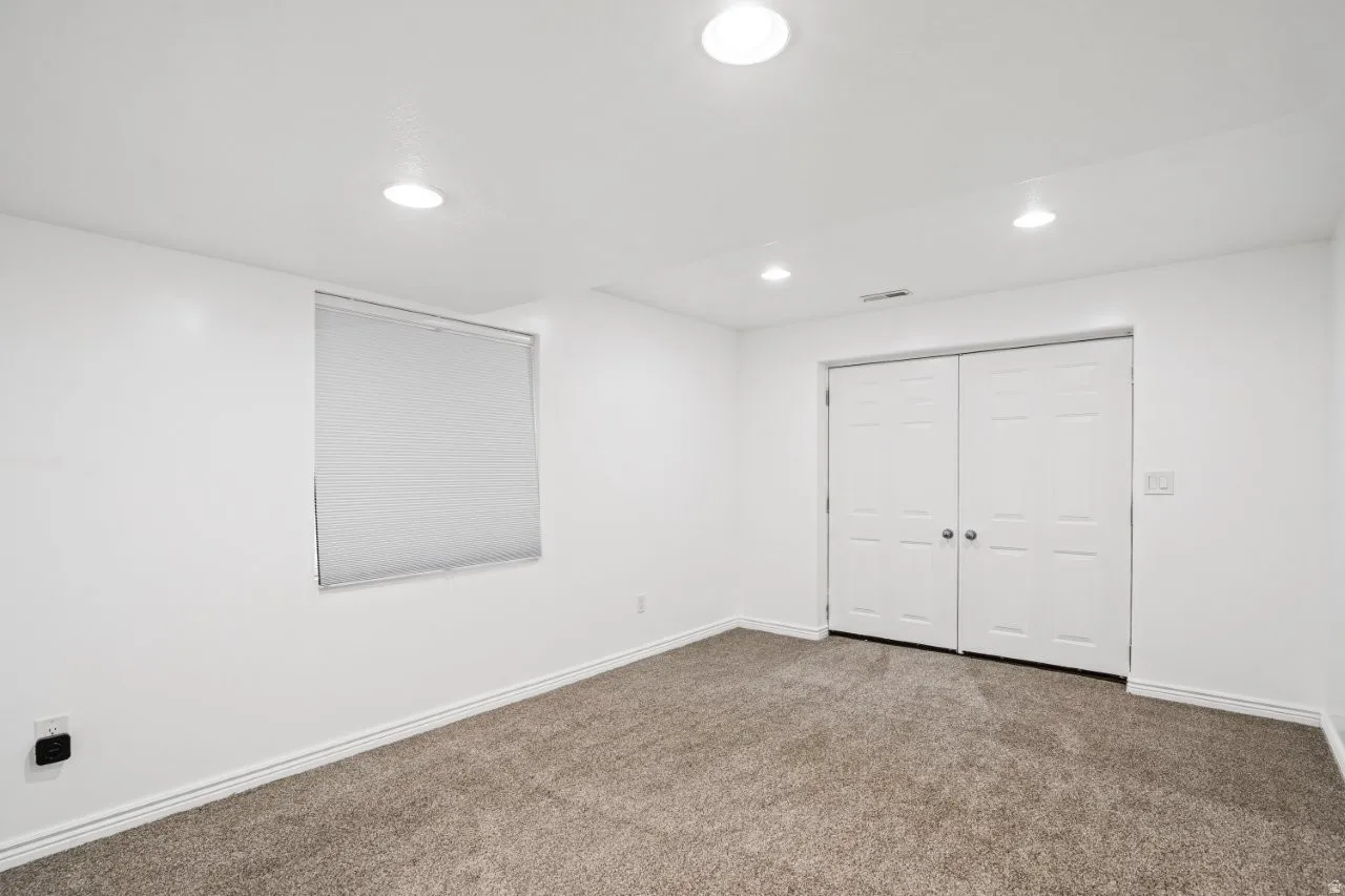 Unfurnished bedroom with carpet, recessed lighting, and a closet
