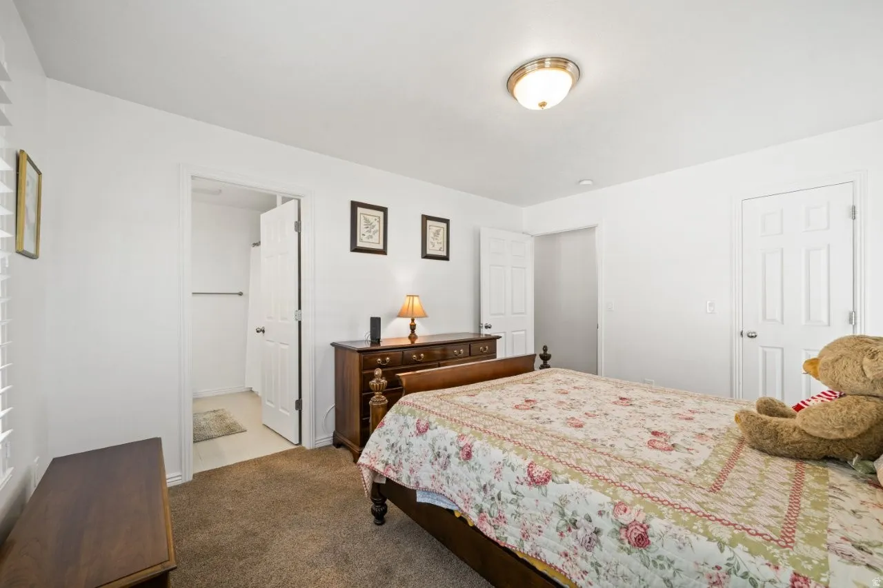 Bedroom featuring dark carpet