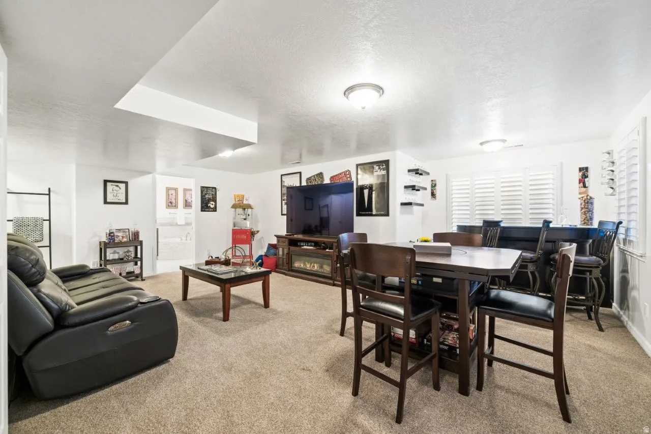 Living room with light colored carpet and a textured ceiling