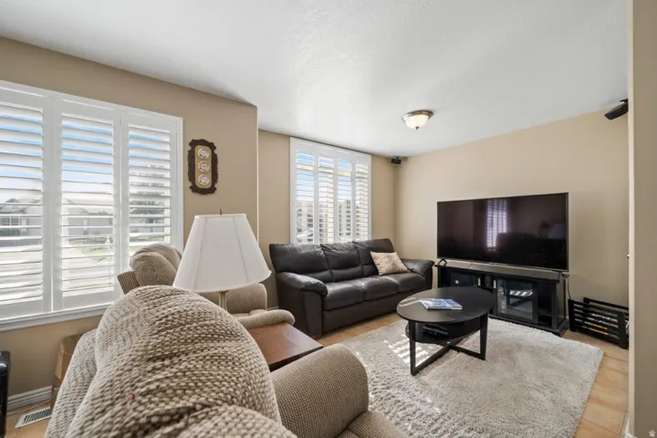 Living room with a textured ceiling and light wood-style flooring