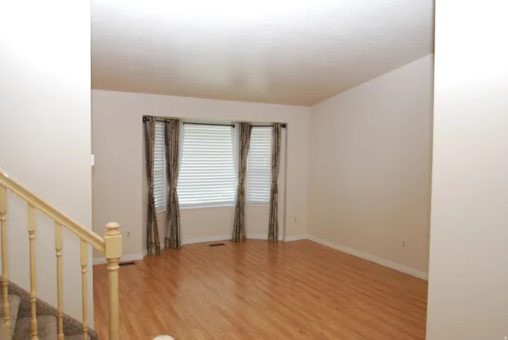 Light wood-finish flooring complements neutral wall tones