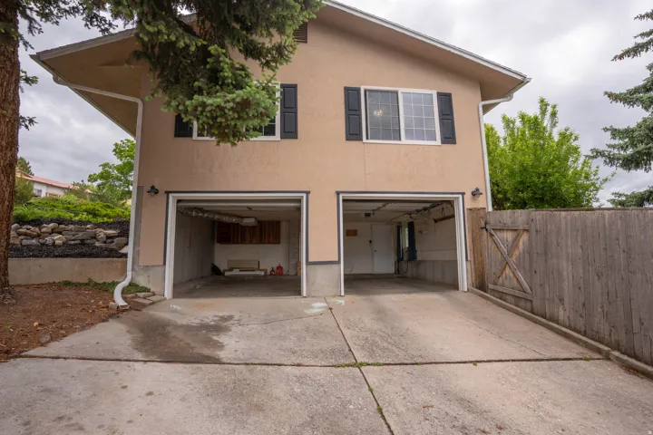 Two-car garage with concrete driveway and stucco exterior