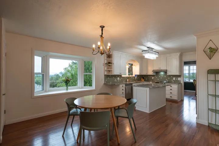Kitchen and dining, island with counter, bay window for views, fun custom tile!  You'll love the kitchen !