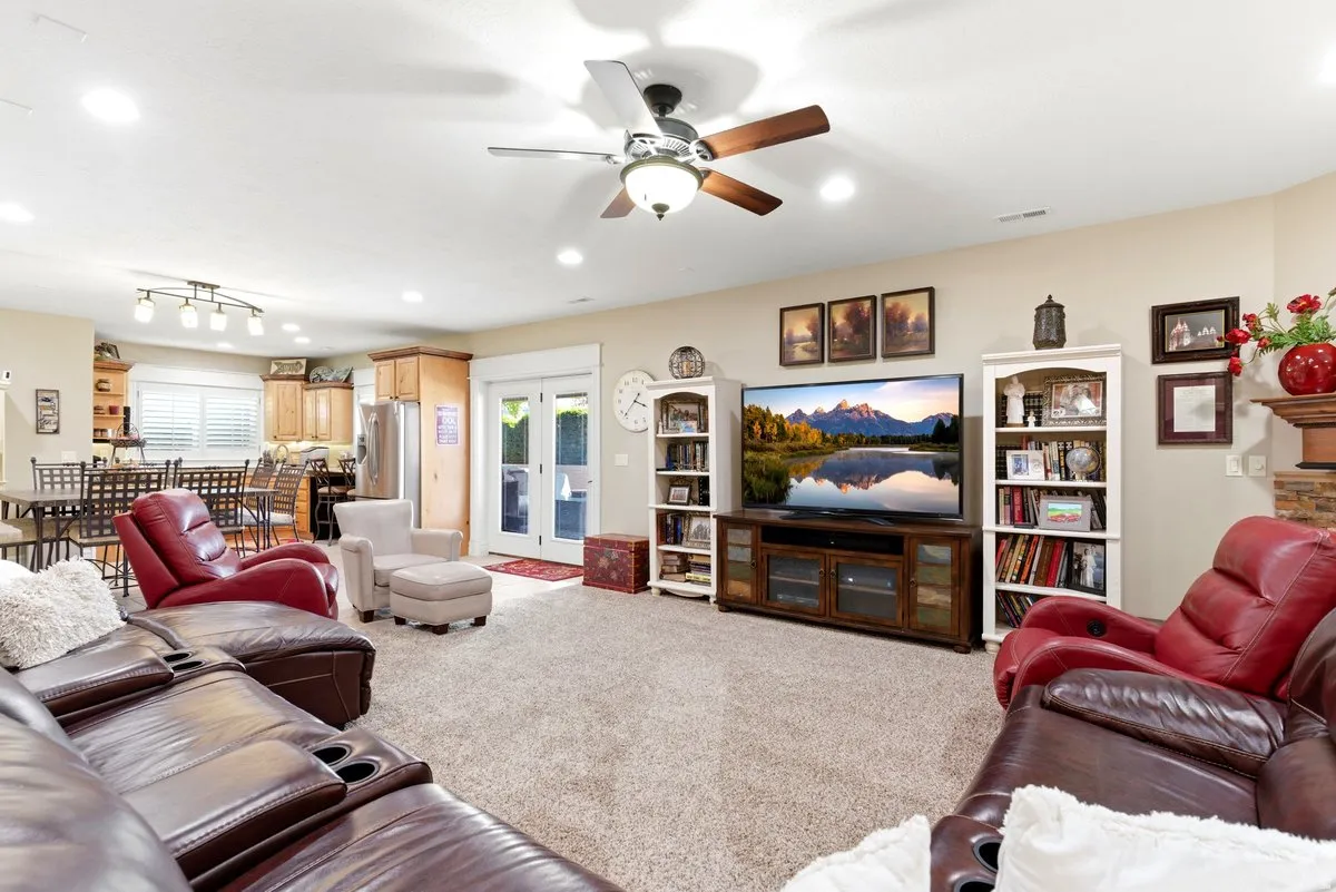 Spacious living area featuring neutral carpeting and recessed lighting