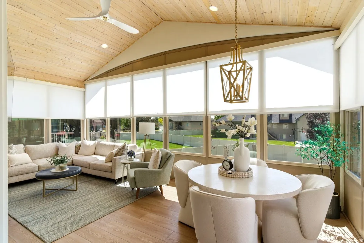 Sunroom featuring a vaulted wood-paneled ceiling, recessed lighting, and a modern ceiling fan