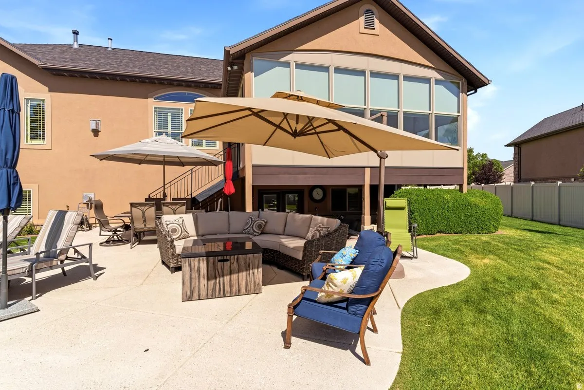 Expansive concrete patio with a curved edge and integrated lawn space