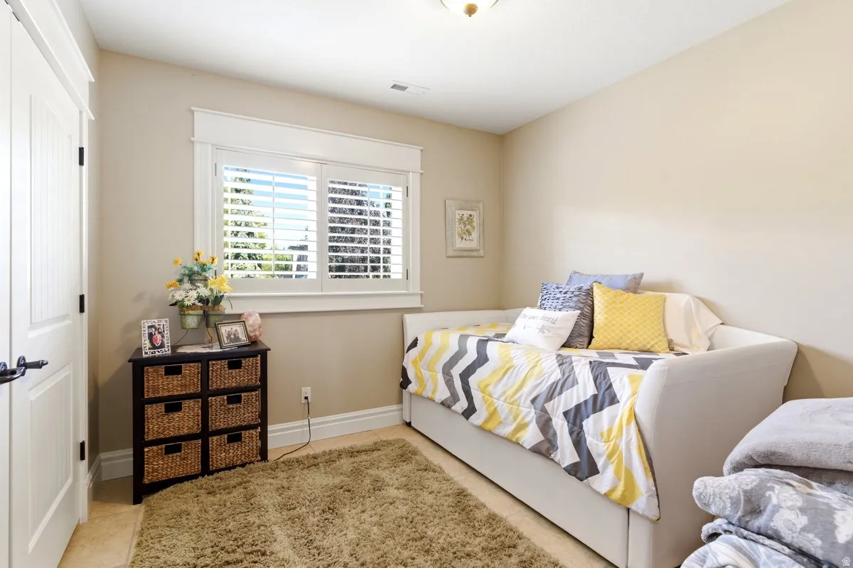 Bedroom with neutral-toned walls and plush carpeting