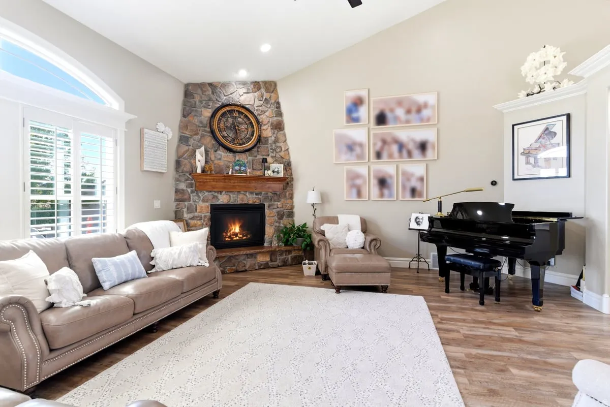 Spacious living area featuring a vaulted ceiling and wood-finish flooring