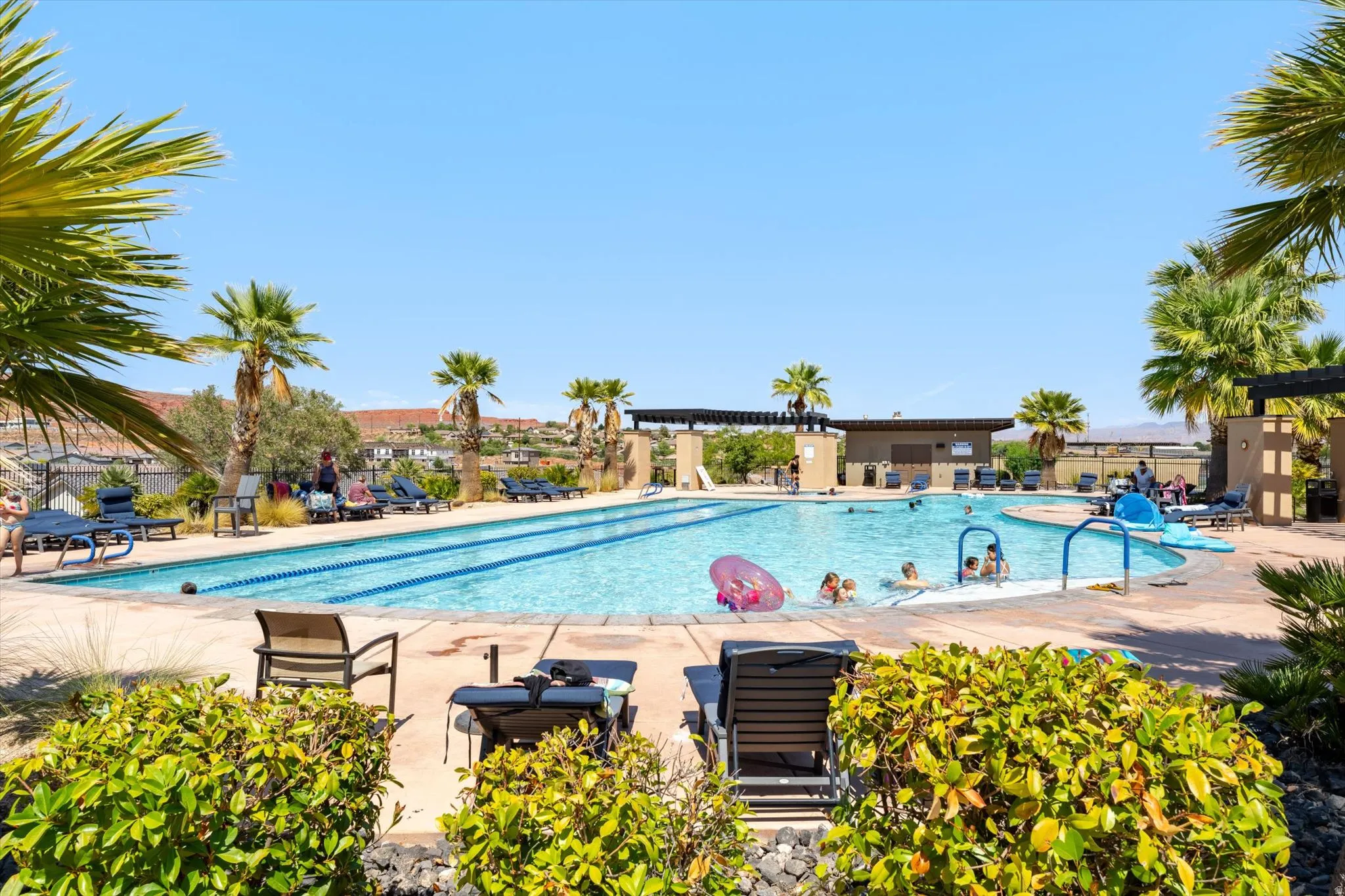 Expansive outdoor pool with integrated lap lanes and a separate shallow wading area