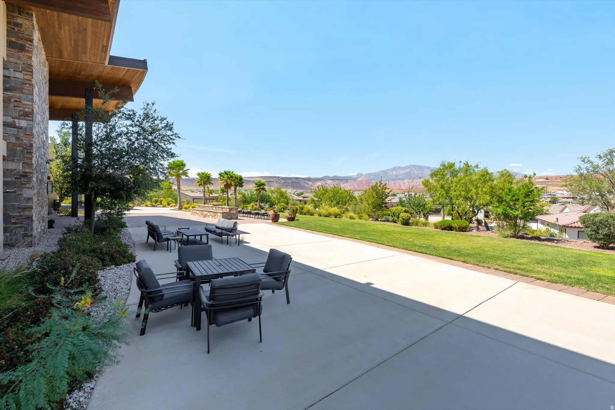 Exterior patio featuring stone accents and wood-finish soffit