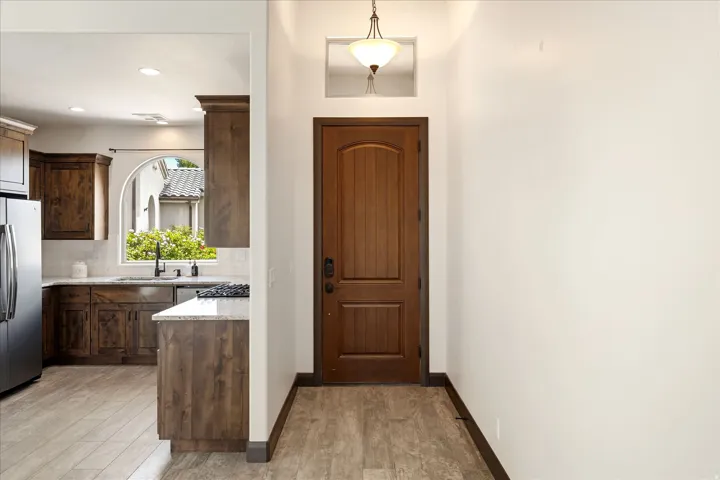 Arched kitchen window overlooking exterior landscaping