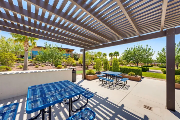 Expansive outdoor patio featuring a slatted pergola