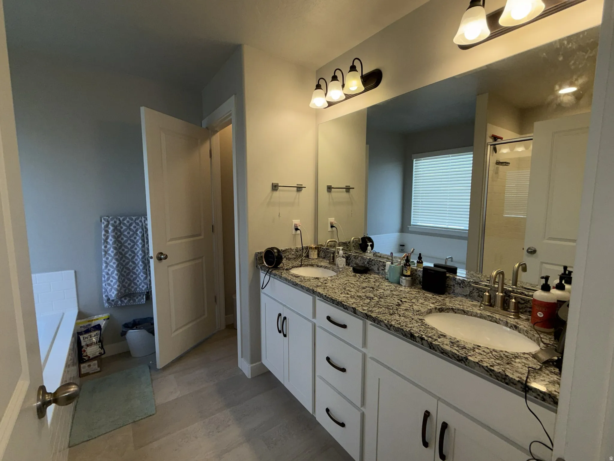Double vanity featuring granite countertops and undermount sinks