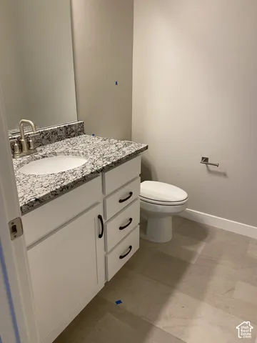 Contemporary vanity with a granite countertop, undermount sink, and brushed nickel faucet