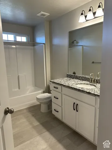 Bathroom featuring a white vanity with black hardware, granite-look countertop, and undermount sink