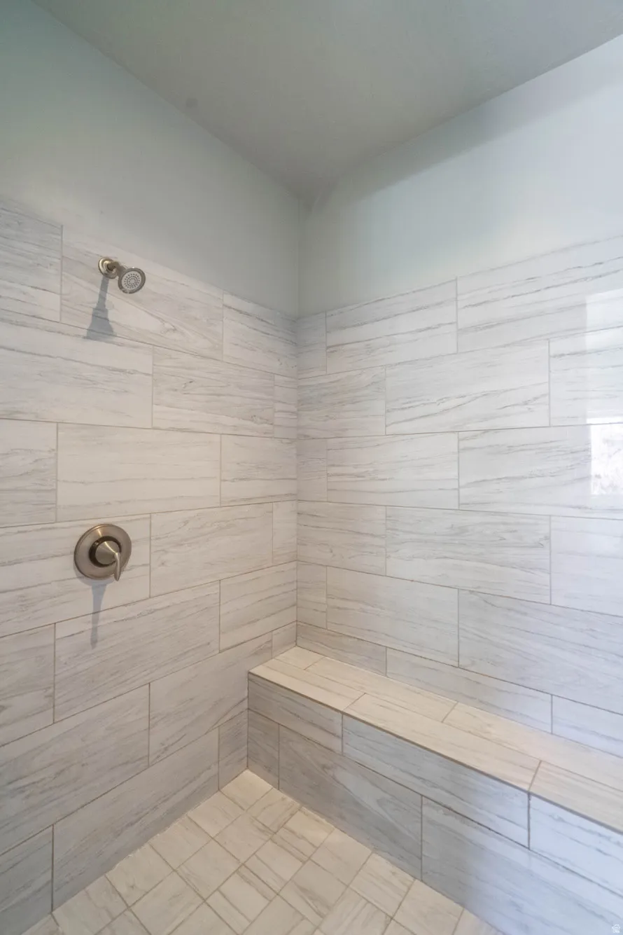 Walk-in shower with large format tile walls and a coordinating tile floor
