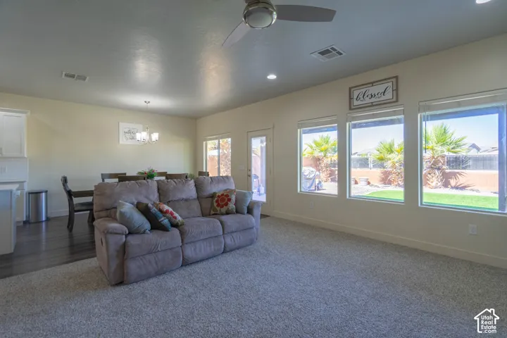 Open-concept living space featuring carpeted flooring, recessed lighting, and a ceiling fan