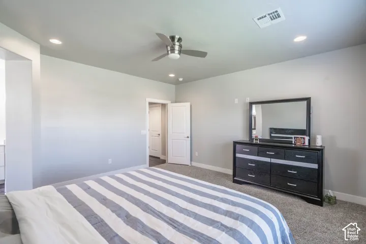 Spacious room featuring neutral carpeting and light gray wall tones
