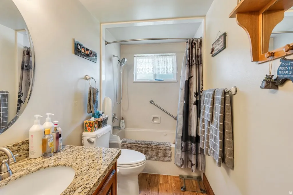 Bathroom featuring a vanity with a granite countertop, undermount sink, and chrome faucet