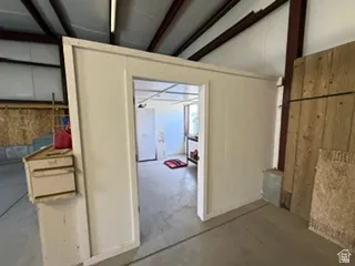 Interior structure featuring a white painted wall with an open doorway
