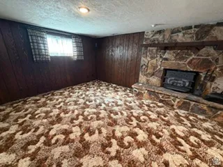 Stone fireplace with an integrated firebox and a wood mantel