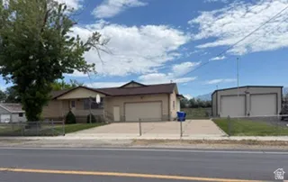 Ranch-style residence featuring a two-car garage and a paved driveway