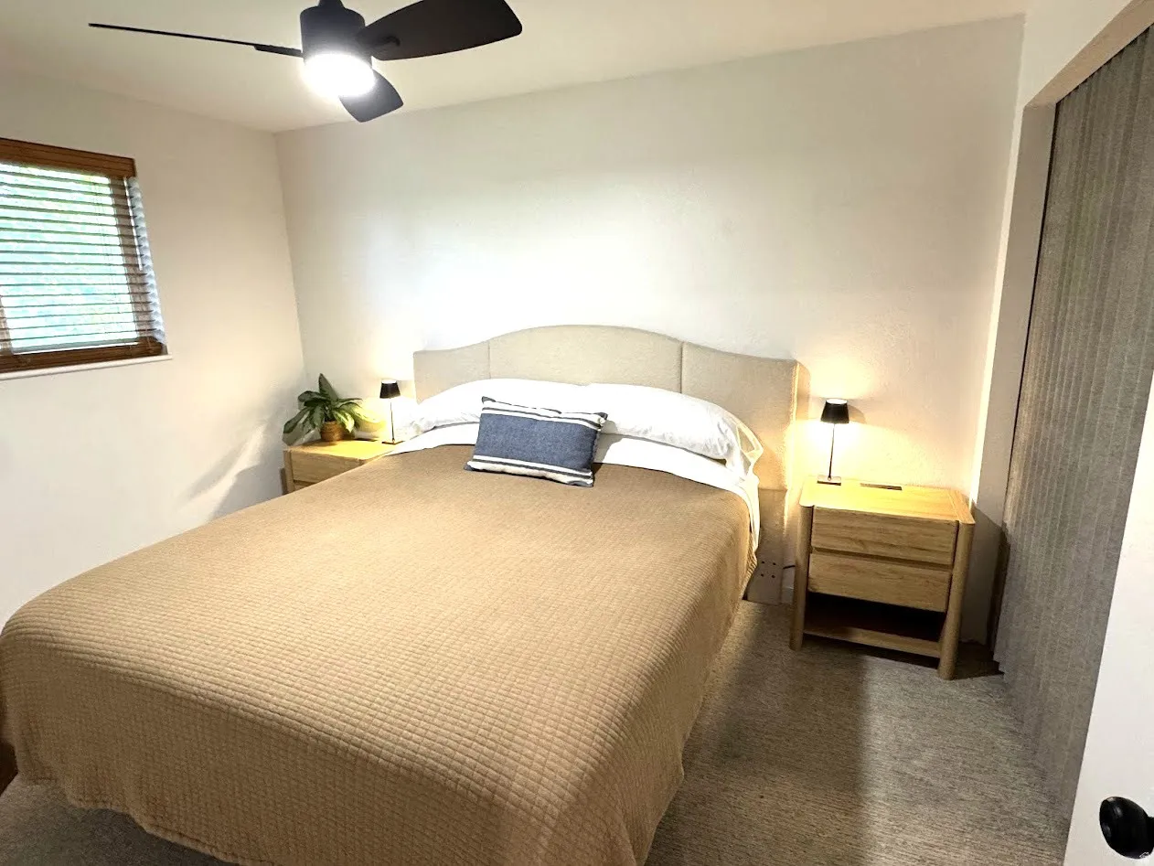 Neutral tone walls complement the light-colored carpet flooring