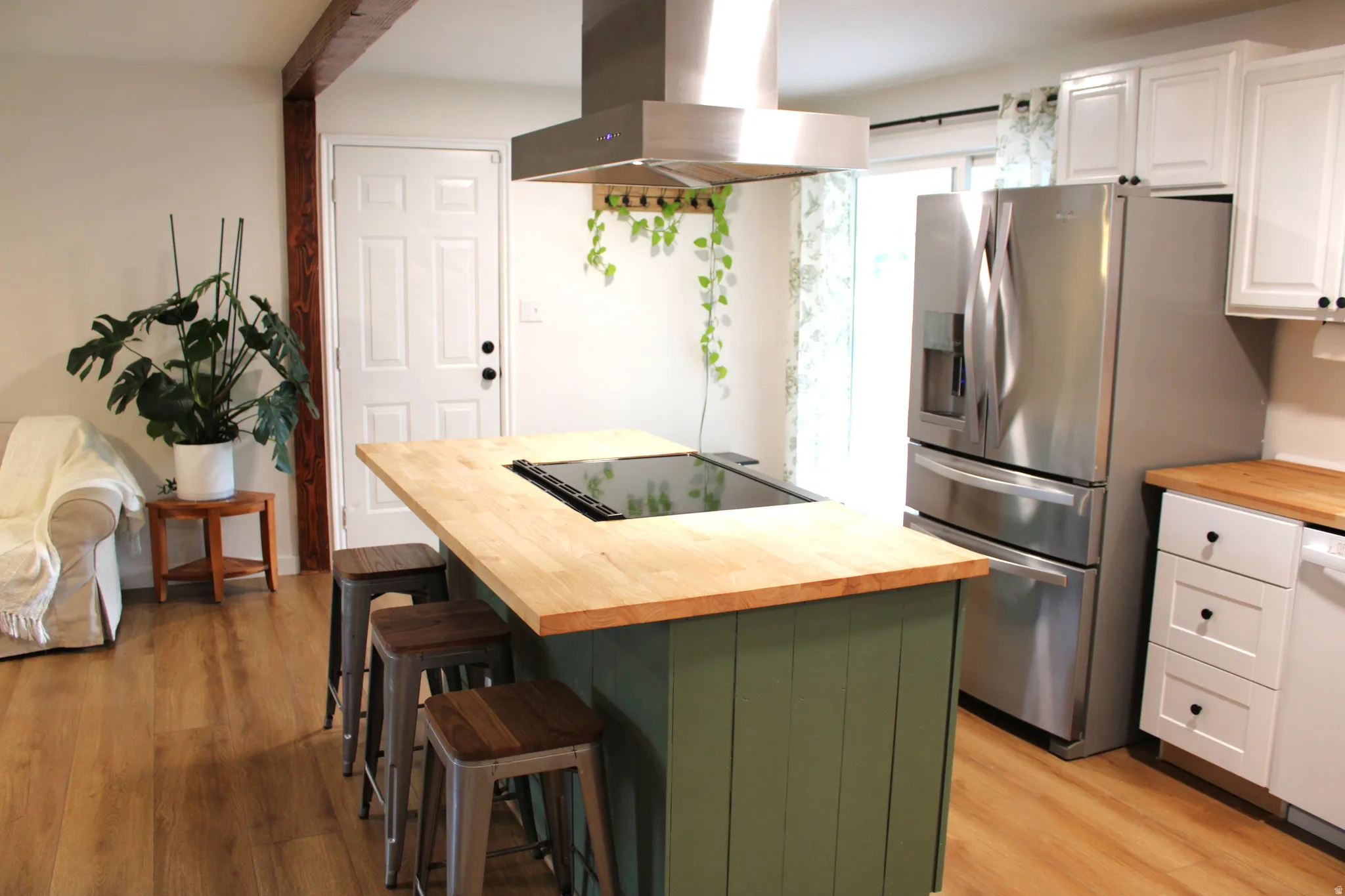 Kitchen featuring a center island with a built-in cooktop and wood-finish countertop
