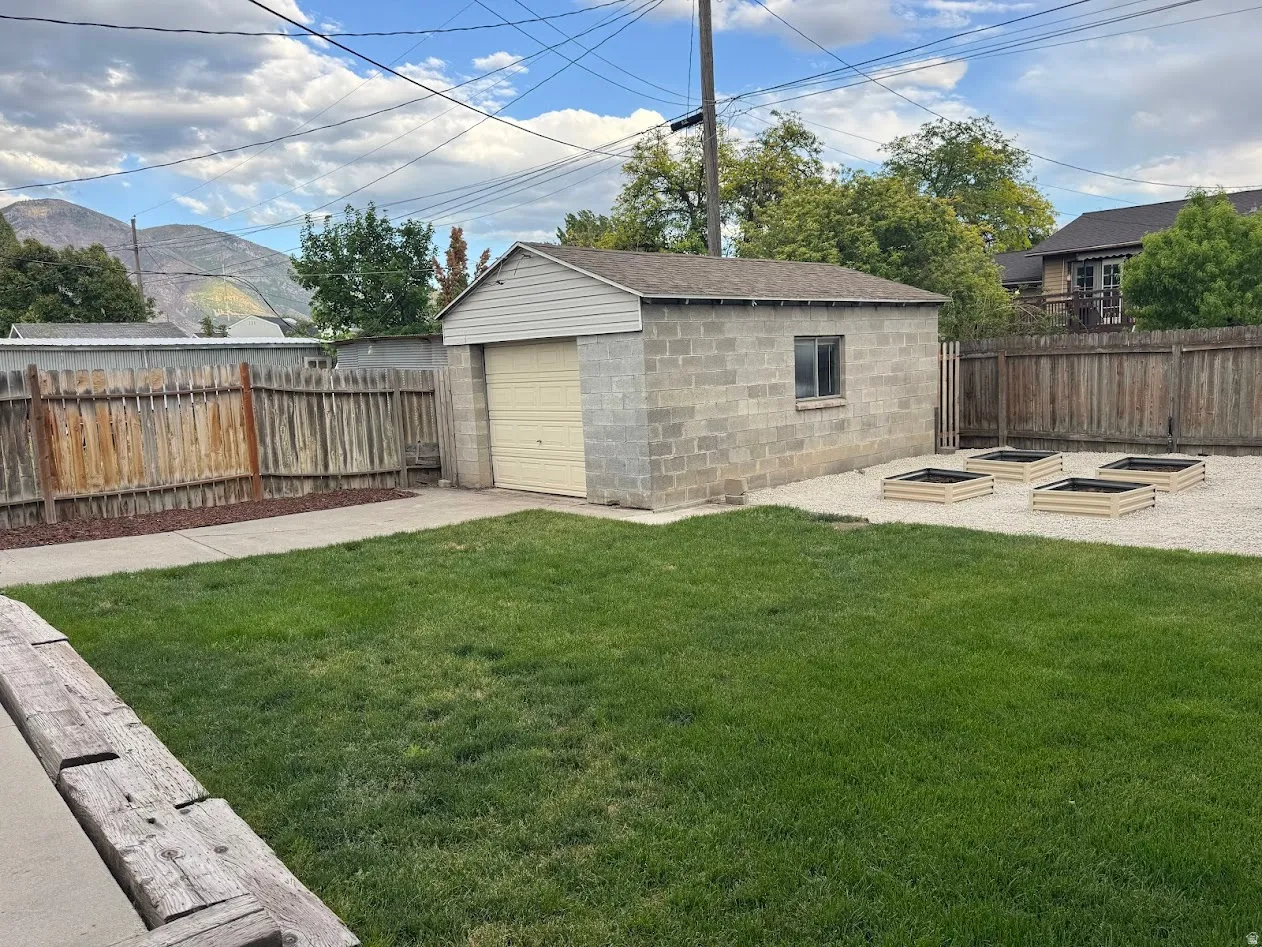 Detached garage with concrete block construction and roll-up door