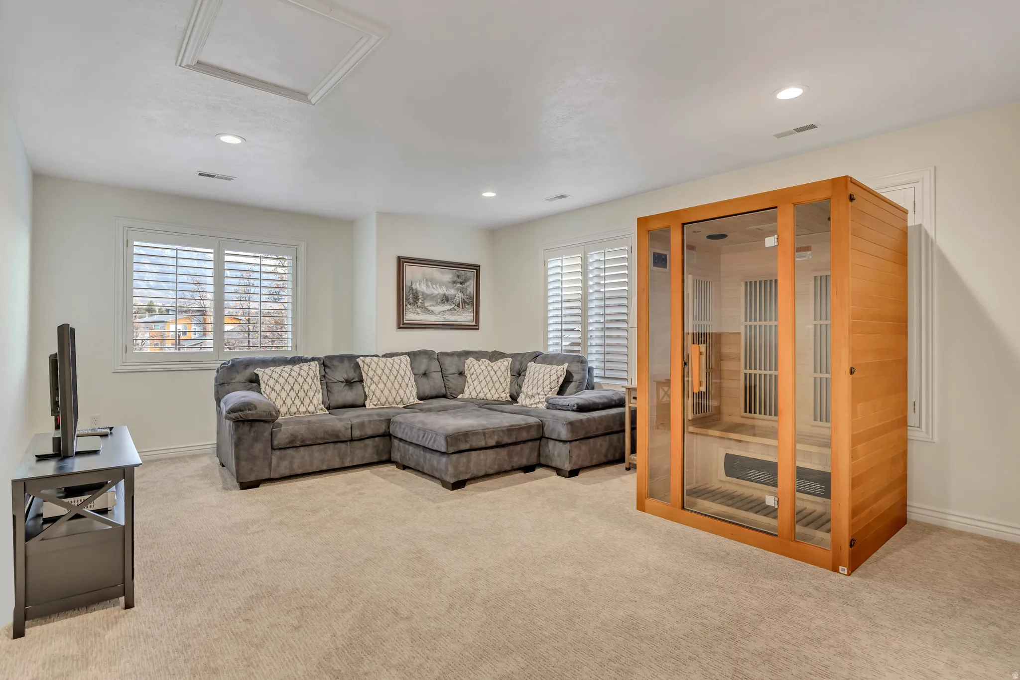 Carpeted bonus room with recessed lighting and crown molding