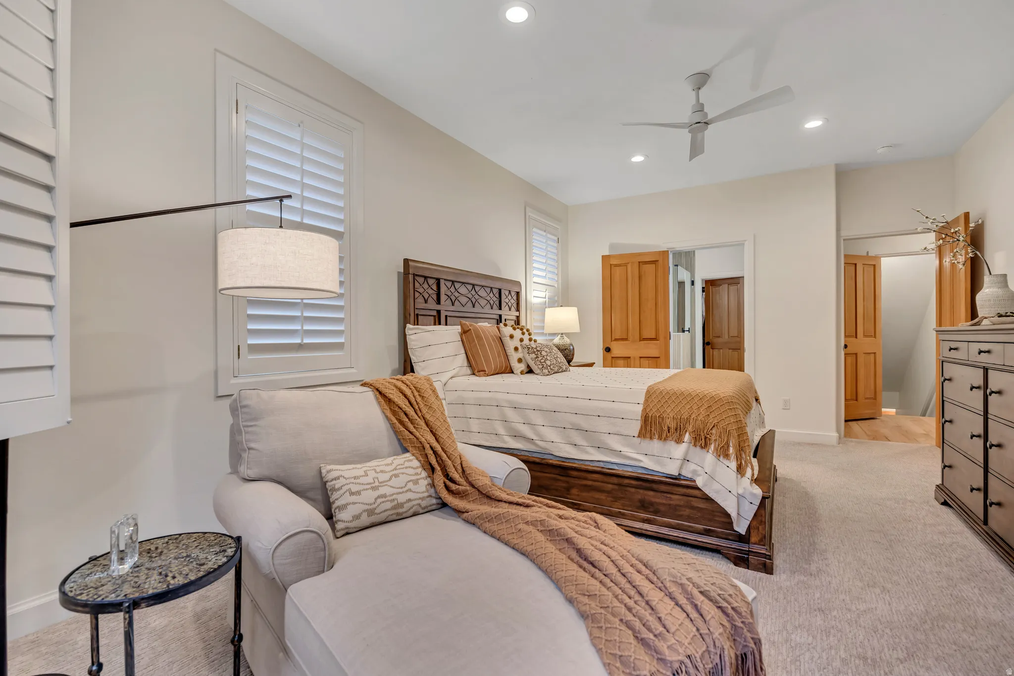 Spacious bedroom featuring light-toned carpeting, recessed lighting, and a modern ceiling fan