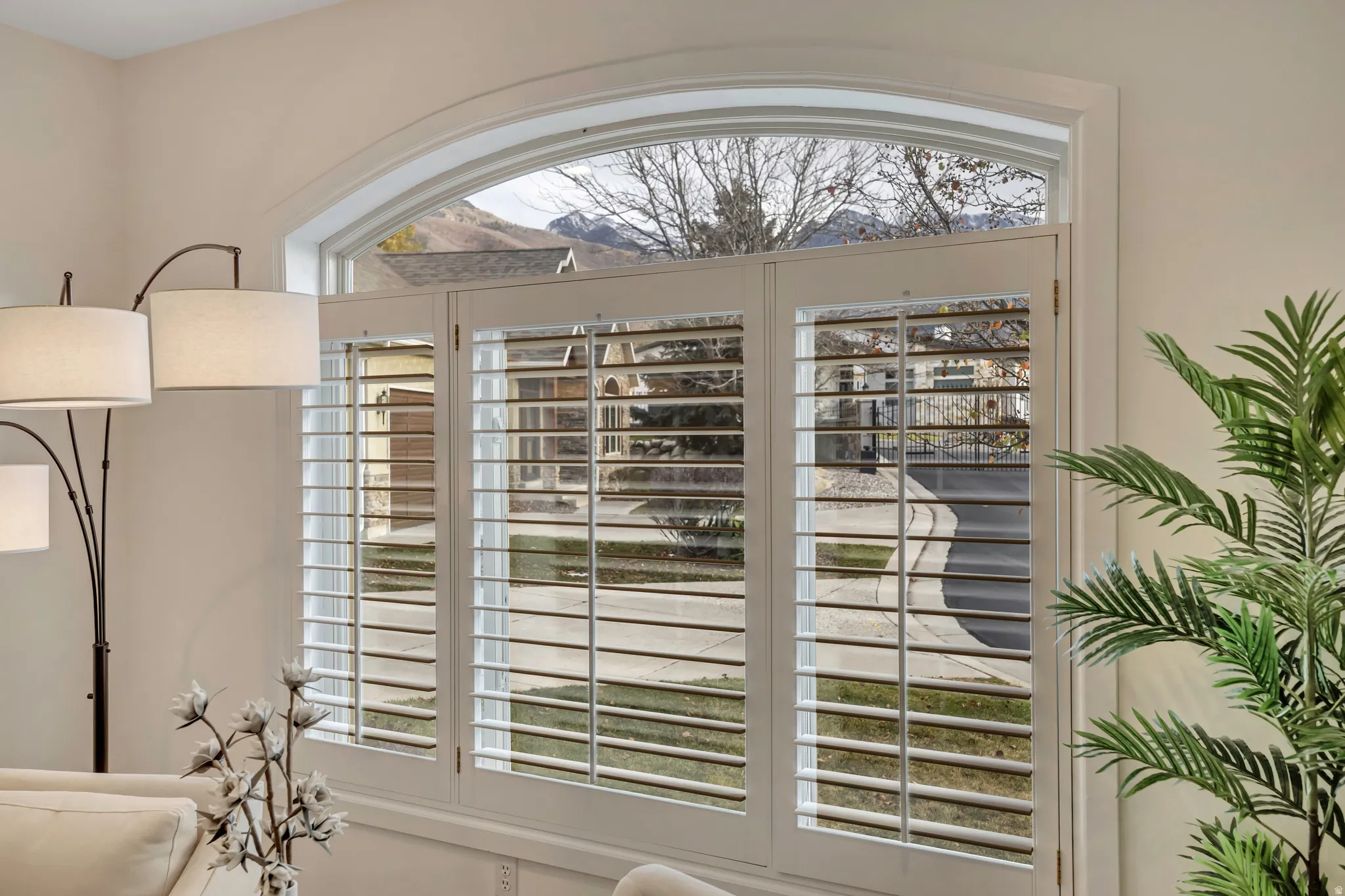 Arched window with custom plantation shutters