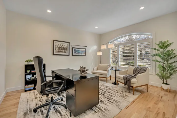 Light wood-finish flooring complements the room's neutral wall tones