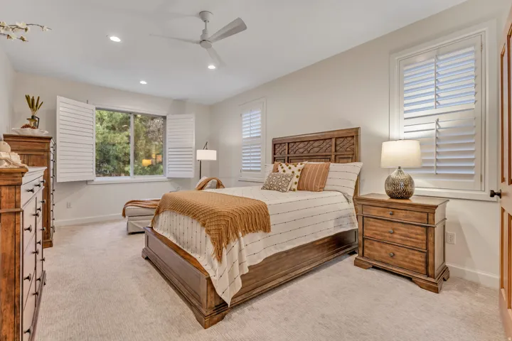 Neutral tone wall paint, recessed lighting, and a contemporary ceiling fan