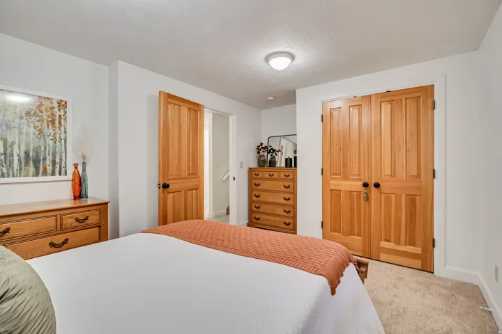 Warm wood-finish double doors and a single panel door provide entry points within this room